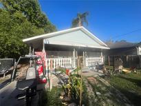 Charming single story home with a covered front porch and home gym at 8203 N Semmes St, Tampa, FL 33604