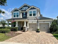 Charming two-story home featuring a large brick driveway, well-manicured lawn and two car garage at 12327 Eagle Swoop Pl, Riverview, FL 33579
