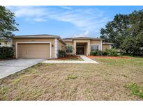 Charming single-story home featuring a well-maintained lawn and two car garage in a desirable location at 14042 Marlberry Way, Odessa, FL 33556