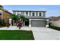 Charming two-story home with a well-maintained lawn and meticulously manicured landscaping at 1712 Crossvine Ct, Trinity, FL 34655