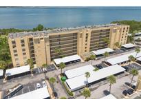 Stunning aerial view of the building, parking, waterfront, and bridge at 2617 Cove Cay Dr # 206, Clearwater, FL 33760