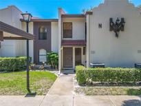 Charming condo featuring a private front entrance and well-manicured landscaping at 3505 Tarpon Woods Blvd # N405, Palm Harbor, FL 34685