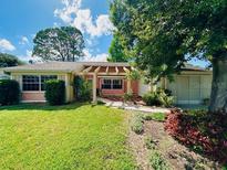 Charming single-story home with a well-manicured lawn and mature landscaping, providing great curb appeal at 3845 Edgemont Dr, New Port Richey, FL 34652