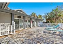 Community deck area with blue lounge chairs and mature palms at 39650 Us Highway 19 N # 553, Tarpon Springs, FL 34689