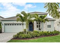 Charming home featuring a beautiful front yard, lush landscaping, and a welcoming entrance at 5413 Wishing Arch Dr, Apollo Beach, FL 33572