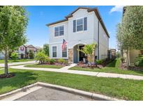 Charming two-story home with a well-manicured lawn and a welcoming front porch at 5717 Village Center Dr, Lithia, FL 33547