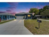 Charming one-story home with a well-manicured lawn and long driveway, inviting curb appeal at 6097 Vermont Ave, New Port Richey, FL 34653
