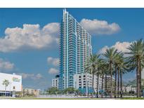 Contemporary high-rise building featuring modern architectural design with balconies and palm trees at 777 N Ashley Dr # 2608, Tampa, FL 33602