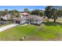 Charming single-story home featuring a well-manicured lawn and inviting walkway to the front door at 9416 Bullfrog Court, Gibsonton, FL 33534