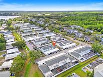 Expansive aerial view showcasing the community's layout with a lake in the distance at 11811 Cypress Crest Cir, Tampa, FL 33626