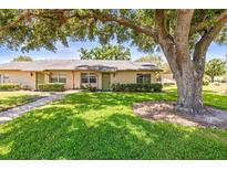 Charming one-story home with well-maintained landscaping and a lush green lawn at 1908 Canterbury Ln # 28, Sun City Center, FL 33573