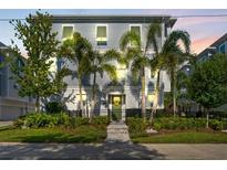 Attractive townhome with mature palm trees, manicured lawn, and a secure fenced yard at 202 S Tampania Ave # 3, Tampa, FL 33609