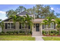 Charming two-story home with a fresh green lawn, beautiful landscaping, and welcoming front entryway at 2933 W Alline Ave, Tampa, FL 33611