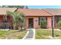 Charming single-story home featuring a pathway and a well-maintained front lawn with a palm tree at 35145 Whispering Oaks Blvd, Dade City, FL 33523