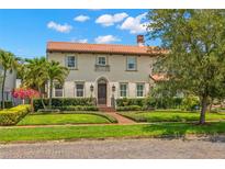 Charming two-story home with a tile roof, manicured lawn, and lush landscaping at 455 18Th Ne Ave, St Petersburg, FL 33704