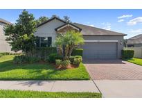 Charming single-Gathering home with well-manicured lawn, brick driveway and 2-car garage at 4690 Coachford Dr, Wesley Chapel, FL 33543