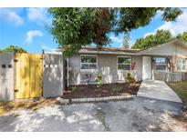 Charming single-story home with stone accents and well-maintained front yard landscaping at 8805 Plum Grove Ct, Tampa, FL 33634
