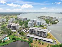 Stunning aerial view of condo community, showcasing beautiful landscaping, waterfront access, and nearby golf course at 100 Oakmont Ln # 310, Belleair, FL 33756