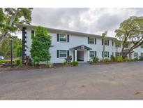 Inviting two-story condo with well maintained landscaping, fresh white paint, and black shutters at 13125 Wilcox Rd # 16202, Largo, FL 33774