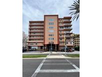 Exterior view of the Ozark condo building with a crosswalk in front and balconies on each level at 16400 Gulf Blvd # 307, North Redington Beach, FL 33708