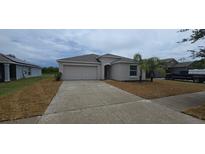 Charming single-story home featuring an attached two-car garage and well-maintained landscaping at 2216 4Th Sw St, Ruskin, FL 33570