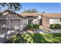 Charming single-story home featuring a one-car garage, well-maintained landscaping, and a cozy front porch at 35229 Janine Dr, Zephyrhills, FL 33541
