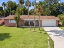 Charming single-story home with a well-manicured lawn, mature trees, and a two-car garage at 4408 Rudder Way, New Port Richey, FL 34652