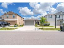 Charming single-Gathering home featuring a two-car garage and well-manicured front lawn on a sunny day at 4507 Eternal Prince Dr, Sun City Center, FL 33573
