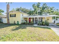 Charming single-story home with mature trees, a well-kept lawn, and a welcoming front porch at 4509 S Cortez Ave, Tampa, FL 33611