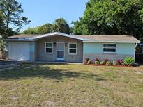Charming single-story home with a well-maintained lawn and a welcoming front entrance at 6731 Old Main St, New Port Richey, FL 34653