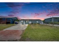 Charming single-story home featuring a well-maintained lawn and a welcoming facade at 825 Seabreeze Dr, Ruskin, FL 33570