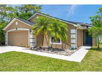 Charming single-story home with a well-maintained lawn, decorative rock garden, and welcoming curb appeal at 8504 Tidal Bay Ln, Tampa, FL 33635