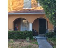 Inviting front entrance featuring a charming porch with arched openings and neat landscaping at 10850 Lake Saint Charles Blvd, Riverview, FL 33578