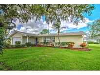 Charming ranch-style home featuring a well-manicured lawn and tasteful landscaping at 2132 Sandpiper Dr, Clearwater, FL 33764