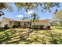 A beautiful home featuring lovely landscaping, mature trees, and great curb appeal at 2132 Sandpiper Dr, Clearwater, FL 33764