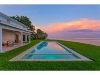 Stunning infinity pool overlooking the ocean and colorful sunset, perfect for relaxing and entertaining at 218 Colony Point S Rd, St Petersburg, FL 33705