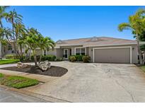 Charming home featuring meticulous landscaping and mature palm trees offering curb appeal and a welcoming entrance at 2773 Seabreeze S Dr, Gulfport, FL 33707