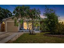 Inviting single-story home featuring a screened porch and well-maintained landscaping at 2807 Northcote Dr, Palm Harbor, FL 34684