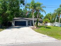 Charming single-story home featuring a spacious driveway and tropical landscaping at 3143 Phoenix Ave, Oldsmar, FL 34677