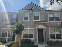 Charming townhome featuring a well-maintained front yard and neutral-toned exterior at 4537 Kennewick Pl # 4537, Riverview, FL 33578