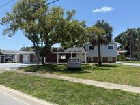 Charming two-story home featuring a well-manicured lawn and mature trees in a serene neighborhood at 4802 Bay Crest Dr, Tampa, FL 33615