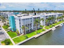 Waterfront condo building with lush landscaping, a private dock, and gorgeous waterfront views at 4904 38Th S Way # 514, St Petersburg, FL 33711