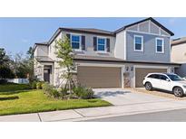 Charming two-story townhome featuring a two-car garage, stone accents, and well-maintained landscaping at 6542 95Th N Pl, Pinellas Park, FL 33782