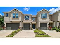 Inviting townhomes with stylish design, blue shutters, and well-kept landscaping at 6745 Citrus Creek Ln, Tampa, FL 33625