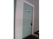 Inviting light blue front door with unit number 201 and secure entry lock at 7927 Kosi Palm Pl # 201, Tampa, FL 33615