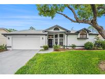 Charming single-story home with a well-manicured lawn, and a two car garage at 8135 Golf Club Ct, Hudson, FL 34667