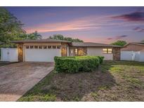 Charming single-story home boasts stone accents, a two-car garage, and a well-manicured front yard at 8744 Andros Ln, Port Richey, FL 34668