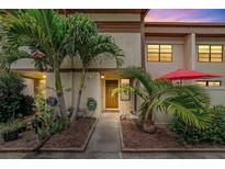 Charming townhome with lush tropical landscaping and a welcoming front entrance at 9209 Seminole Blvd # 156, Seminole, FL 33772