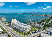 Stunning aerial view of the condominium complex with beautiful ocean and inter-coastal views and boat docks at 100 Bluff View Dr # 405A, Belleair Bluffs, FL 33770