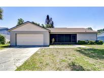 Charming single-story home featuring an attached garage, screened front porch and a well-maintained lawn at 12846 Tallowood Dr, Riverview, FL 33569